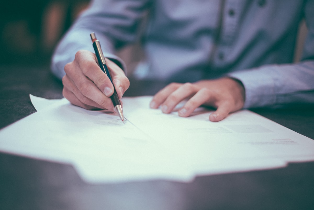 Person reviewing insurance documents and paperwork at a desk