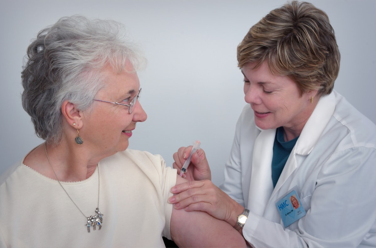 Family caregiver helping an elderly loved one prepare for a medical appointment